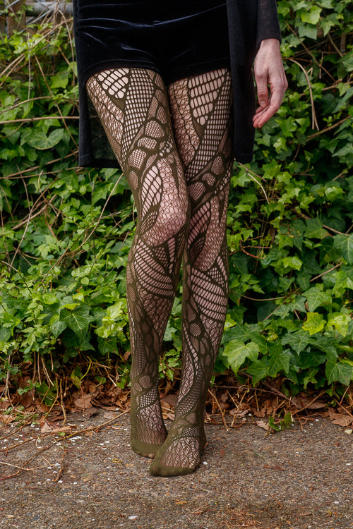 A person wearing celsius net tights in olive color