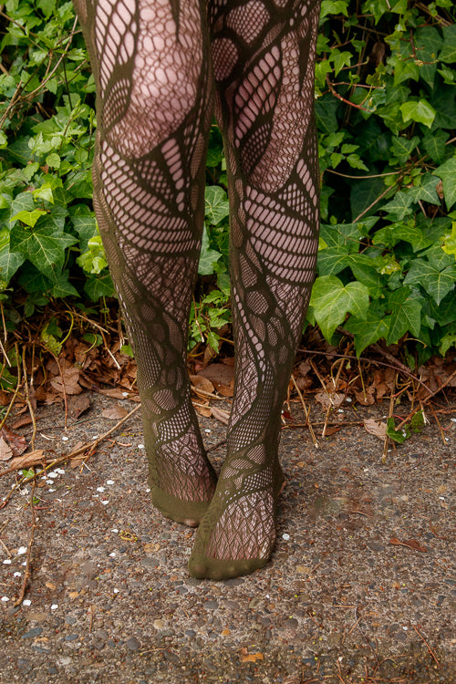 A person wearing celsius net tights in olive color