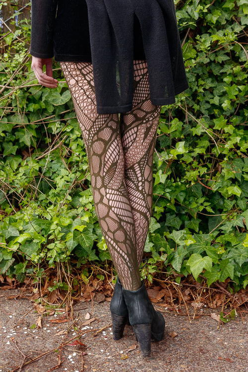 A person wearing celsius net tights in olive color
