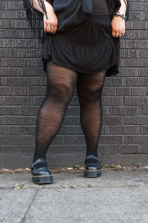 A person wearing Jennifer Wool Tights in black