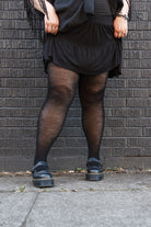 A person wearing Jennifer Wool Tights in black