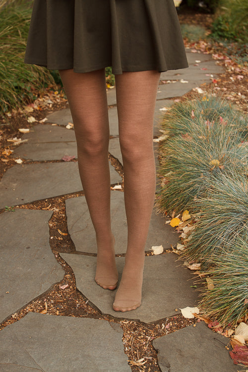 A person wearing Jennifer Wool Tights in hazelnut