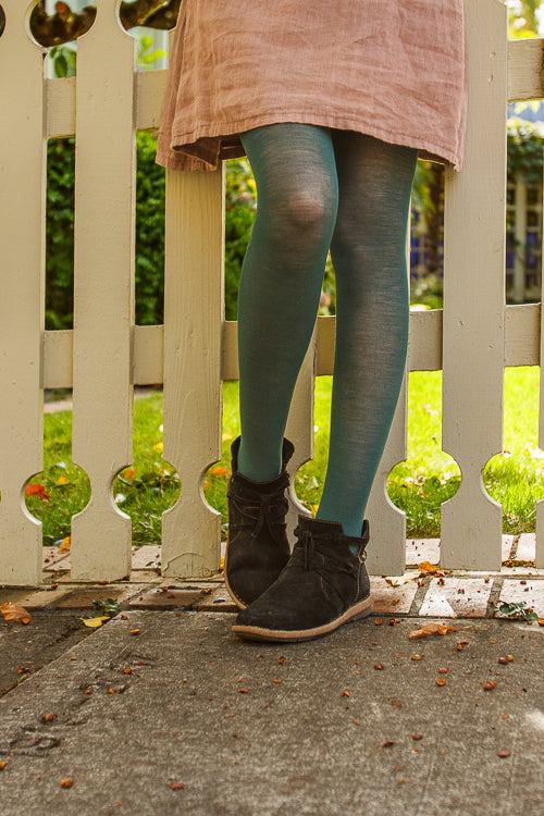 A person wearing Jennifer Wool Tights in pine