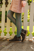 A person wearing Jennifer Wool Tights in pine