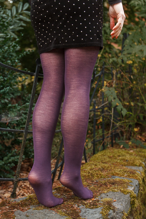 A person wearing Jennifer Wool Tights in prune