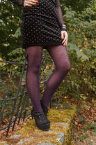 A person wearing Jennifer Wool Tights in prune