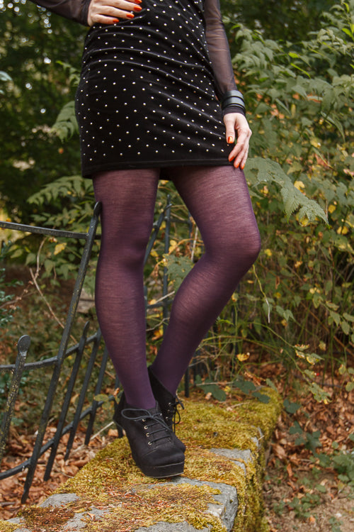 A person wearing Jennifer Wool Tights in prune