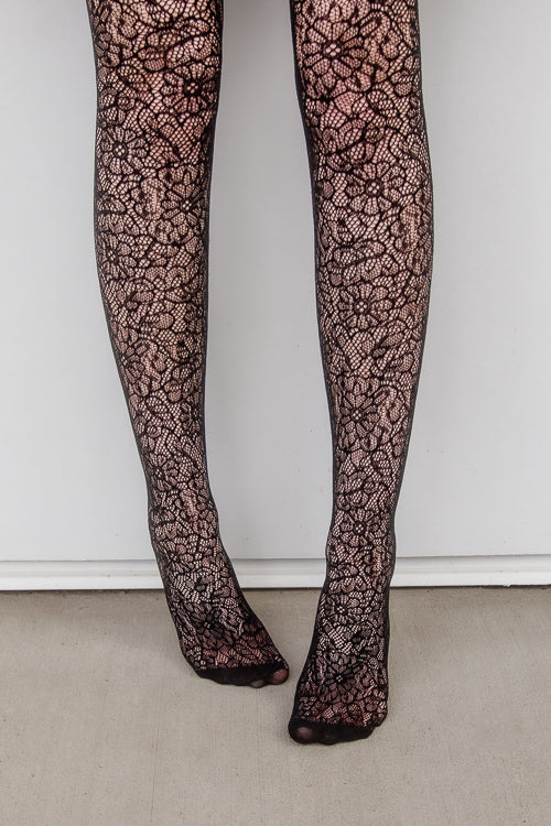 A person wearing Shedar floral net tights in black
