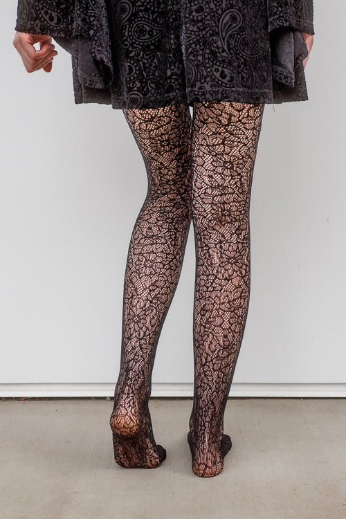 A person wearing Shedar floral net tights in black
