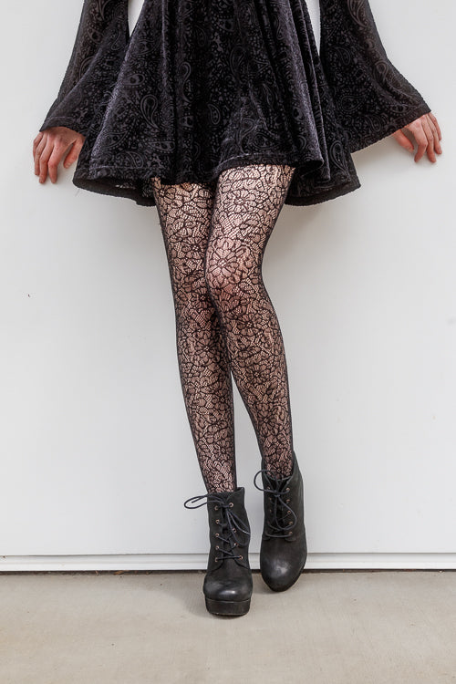 A person wearing Shedar floral net tights in black