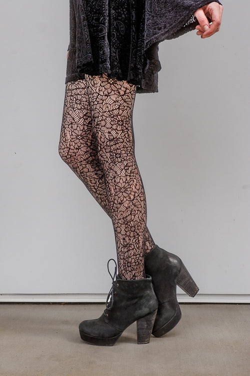 A person wearing Shedar floral net tights in black
