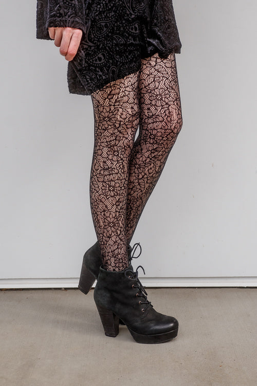A person wearing Shedar floral net tights in black